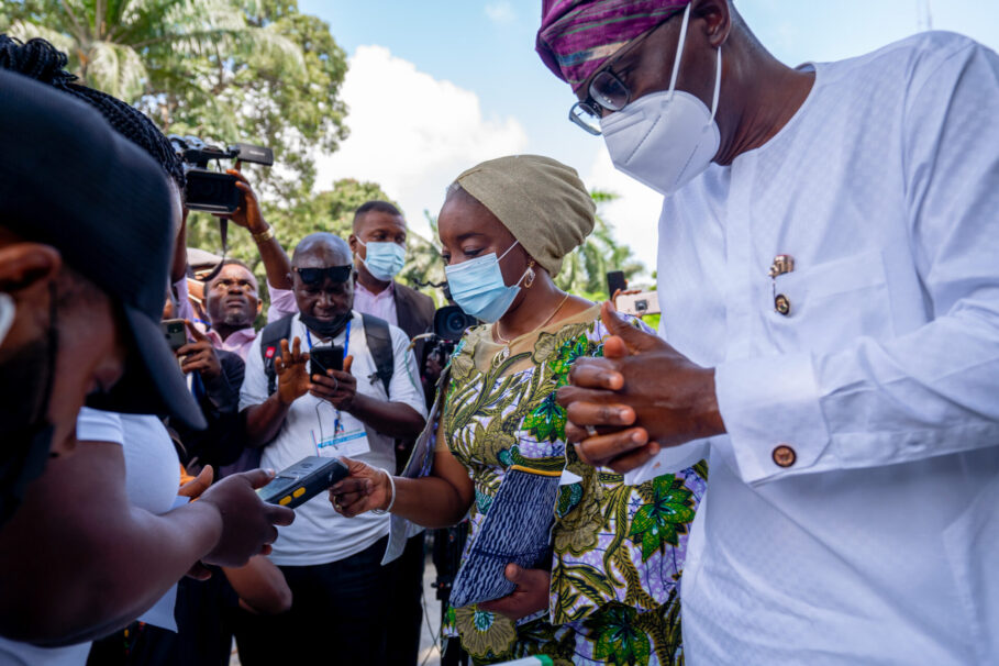 Lagos State Governor, Mr. Babajide Sanwo-Olu (right) and his wife, Dr. (Mrs) Ibijoke in the process of accreditation to cast her vote for the local government chairmanship election