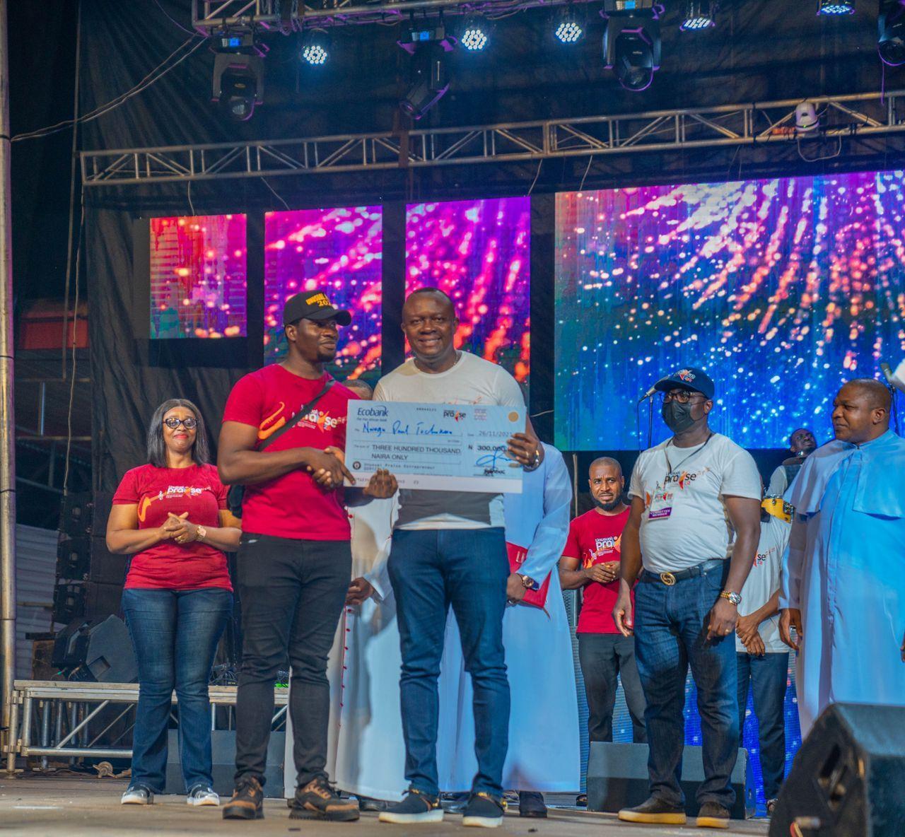 Valentine Ozigbo, offering cash award to winners of he 2021 Unusual Entrepreneurs during the Unusual Praise Event at the Basilica of the Most Holy Trinity, Onitsha