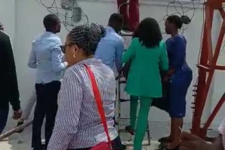 Naira Scarcity: Bankers In Viral Video Flee Angry Customers Through Back Fence