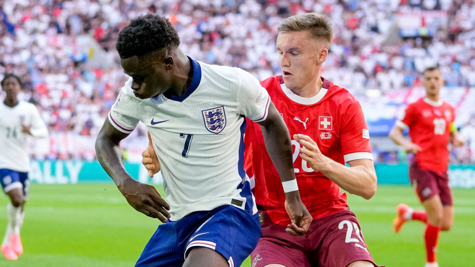 Saka holds off Michel Aebischer in the match against Switzerland