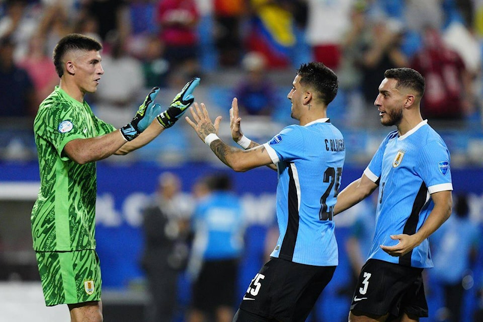 Uruguay’s goalkeeper Sergio Rochet celebrates with teammates after defeating Canada