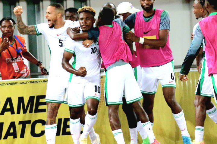 Teammates mob Dele Bashiru after his saved the day with a lone goal