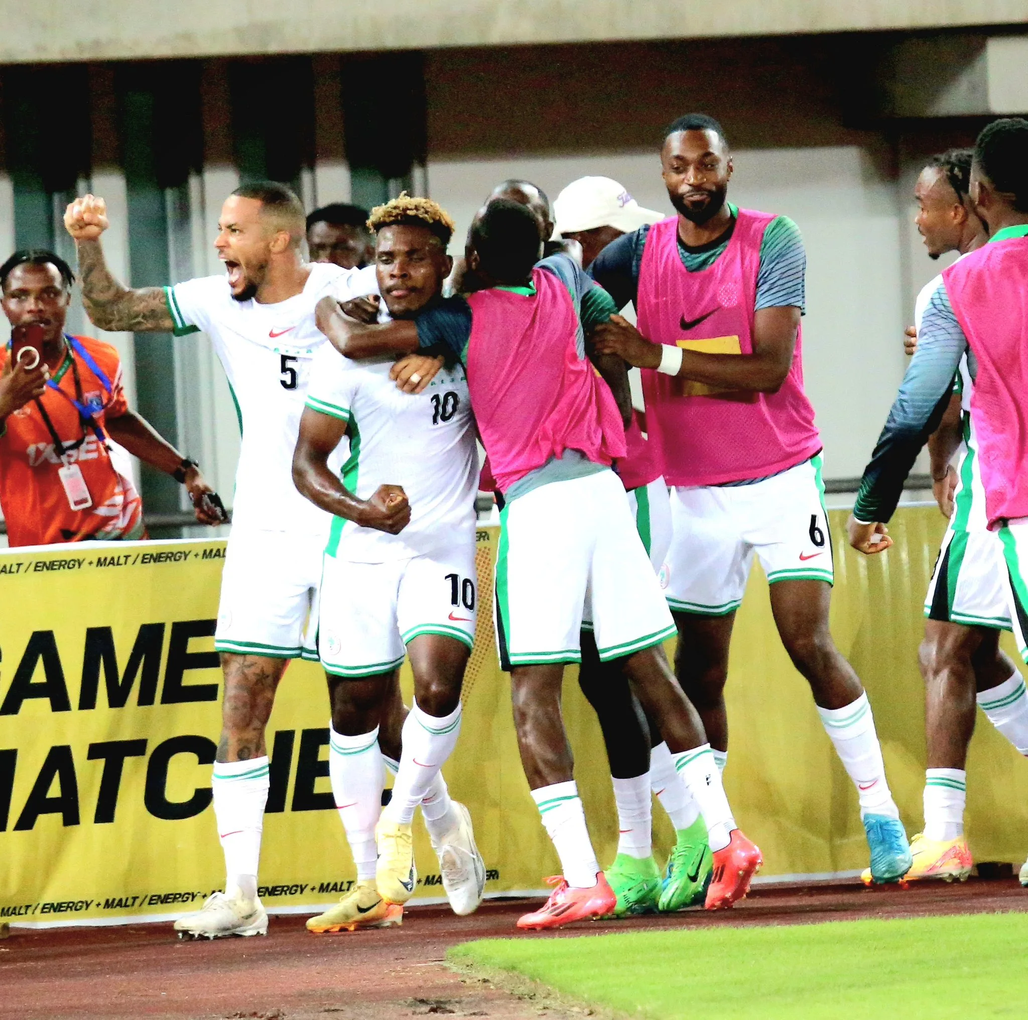 Teammates mob Dele Bashiru after his saved the day with a lone goal