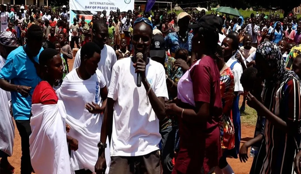 Tambura residents walk and dance their way to Peace Day celebrations