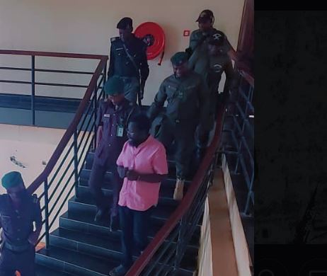 Dele Farotimi in handcuffs (pink shirt) at court today