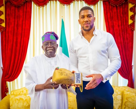 joshua presents president Tinubu wth signed gloves