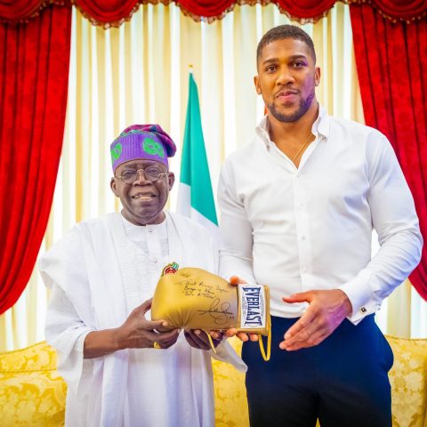 joshua presents president Tinubu wth signed gloves