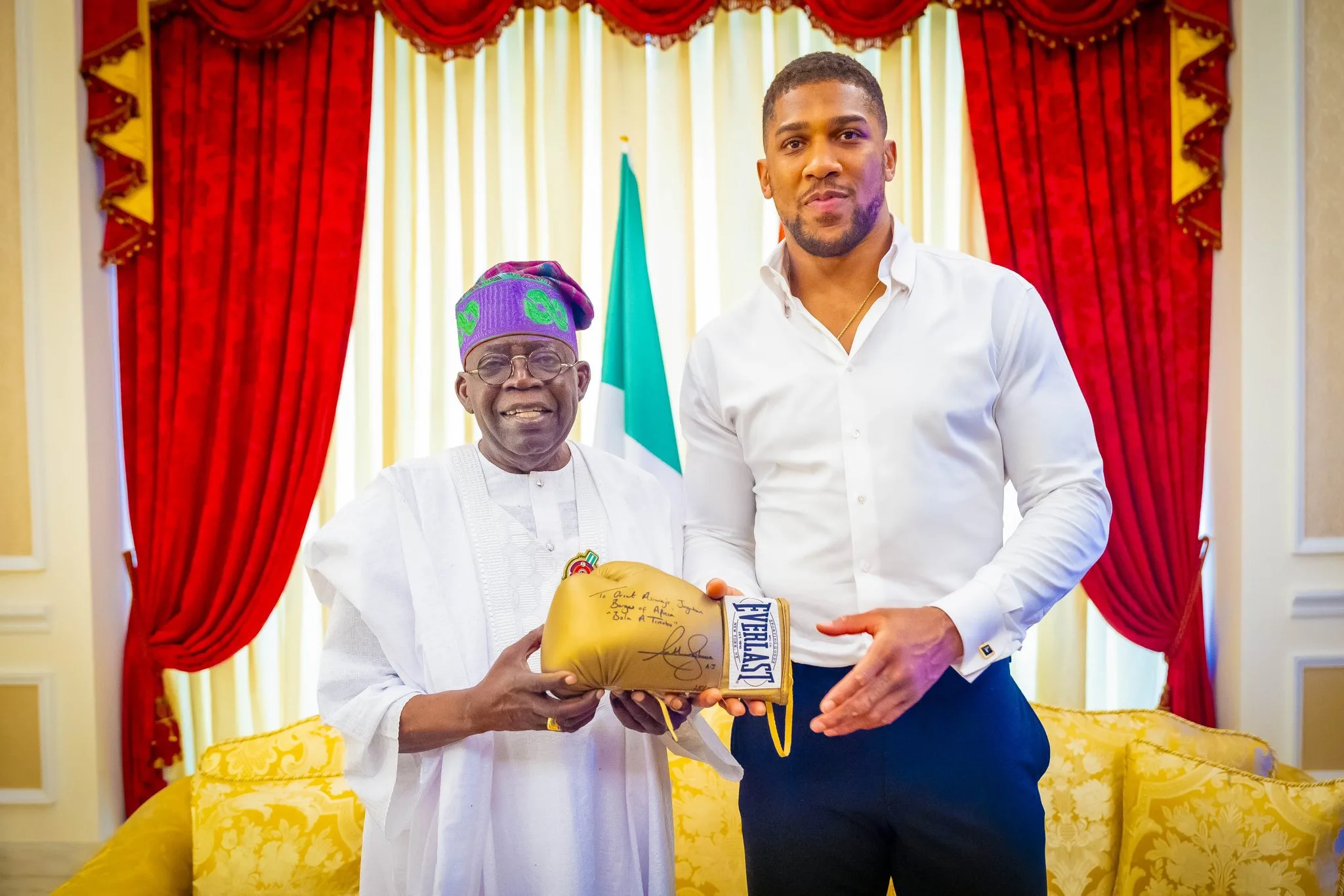 joshua presents president Tinubu wth signed gloves